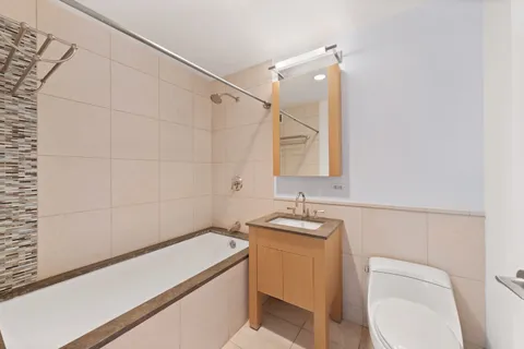 a bathroom with a sink a toilet and mirror