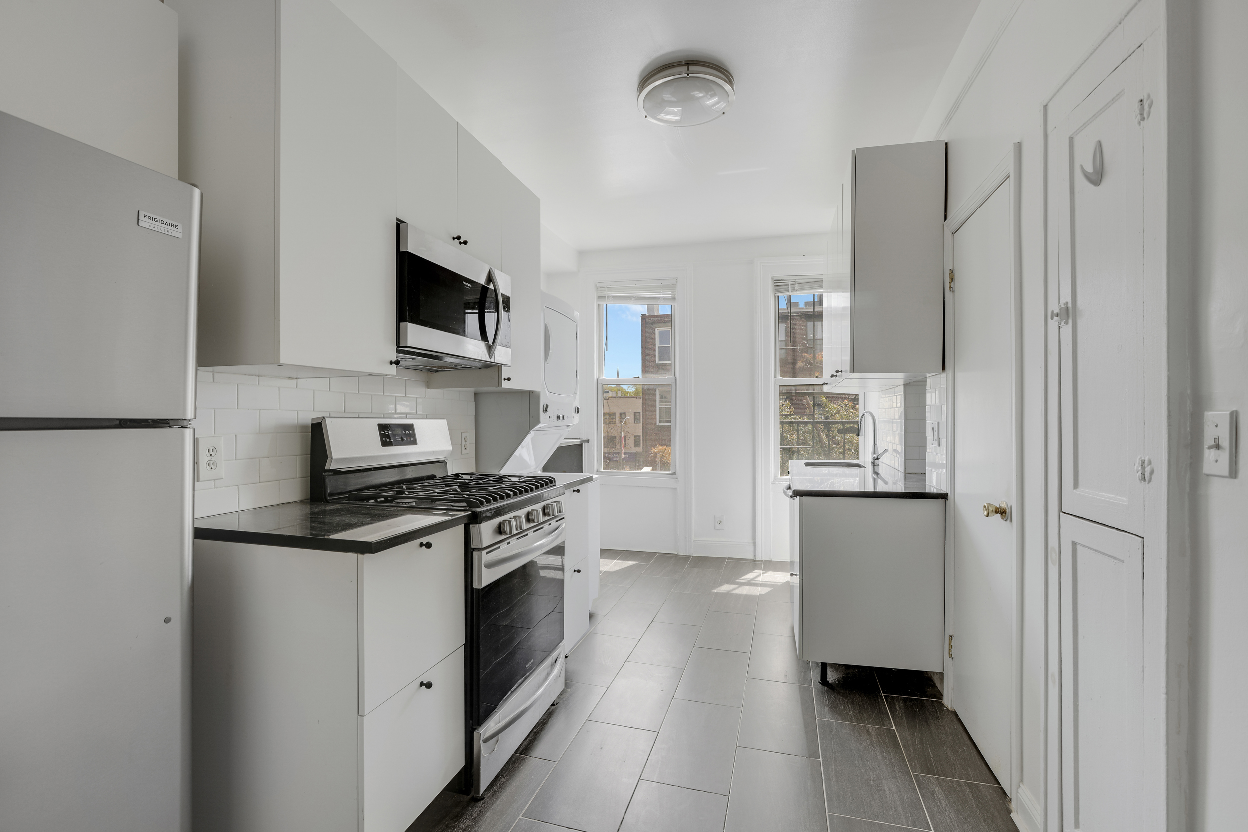 100 Powers Street, Unit 3L Brooklyn, NY 11211 - Photo 9 of 17 a kitchen with stainless steel appliances a refrigerator stove and sink