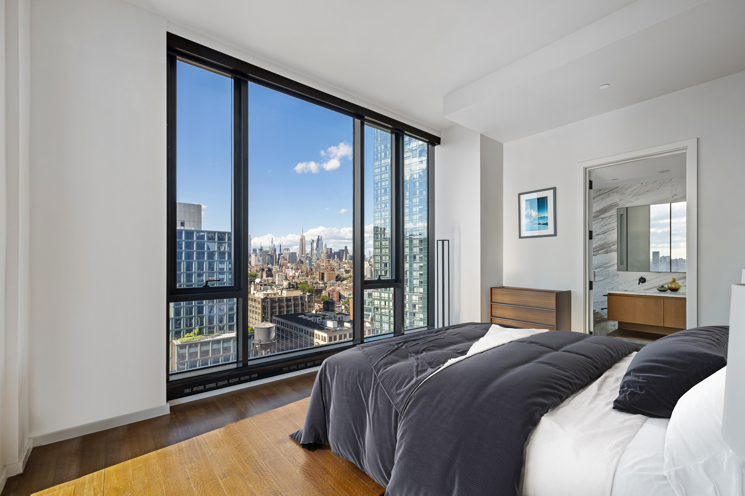 570 Broome Street, Unit 23A Manhattan, NY 10013 - Photo 6 of 13 a bedroom with a large bed and a large window