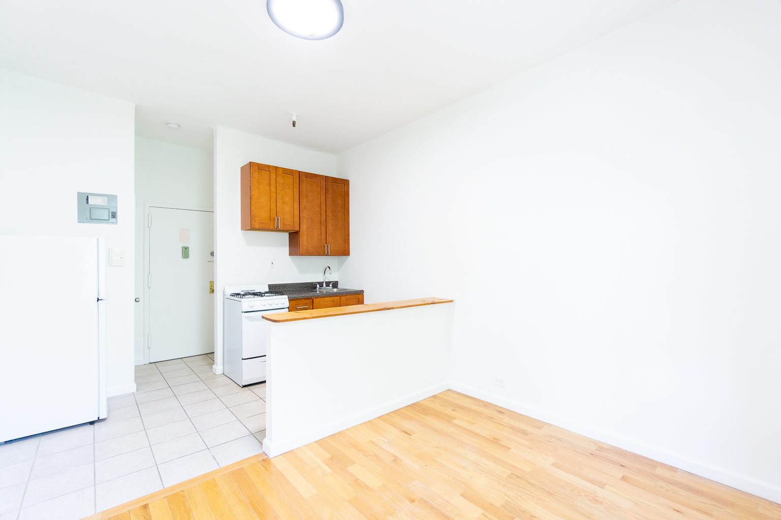 320 West 20th Street, Unit 15 Manhattan, NY 10011 - Photo 3 of 8 a bathroom with a sink a toilet and mirror