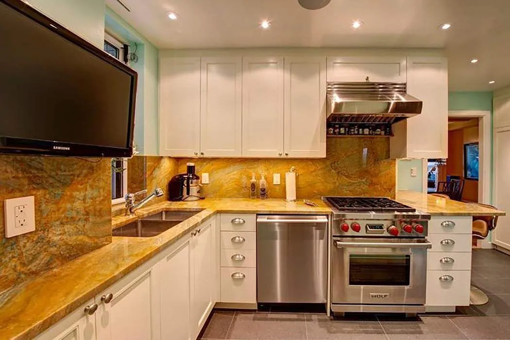 a kitchen with stainless steel appliances a stove a sink and a microwave