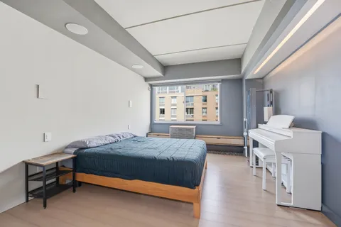 a bedroom with a bed and a table in it