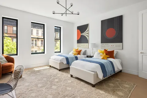 a bedroom with bed couch and window