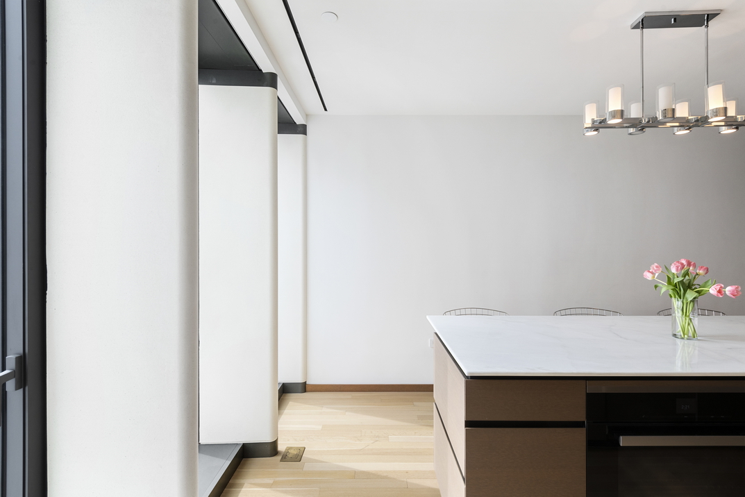 551 West 21st Street, Unit 4D Manhattan, NY 10011 - Photo 6 of 16 a room with a table and chandelier