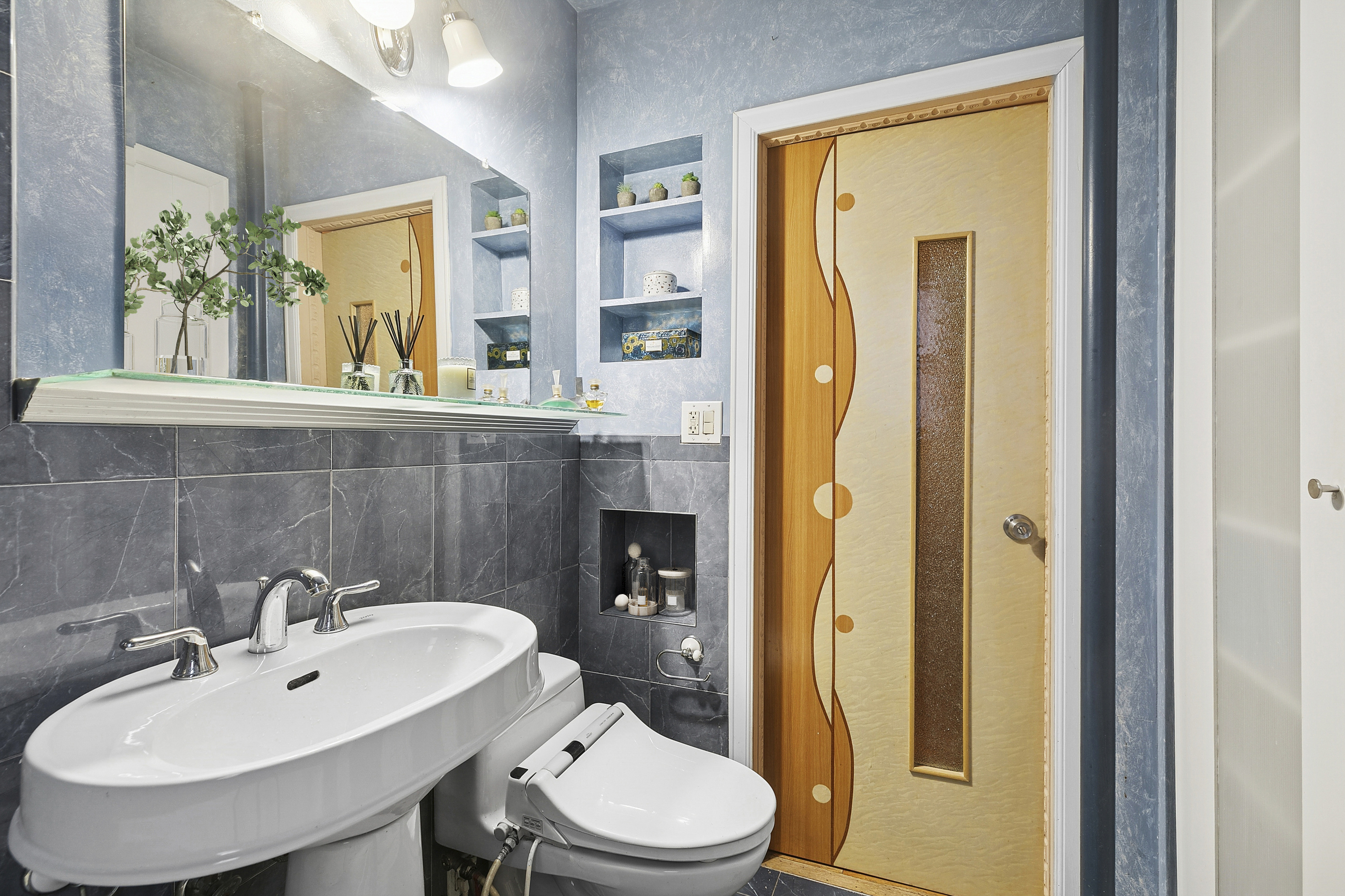 3025 Ocean Avenue, Unit 1O Brooklyn, NY 11235 - Photo 7 of 9 a bathroom with a sink and a mirror