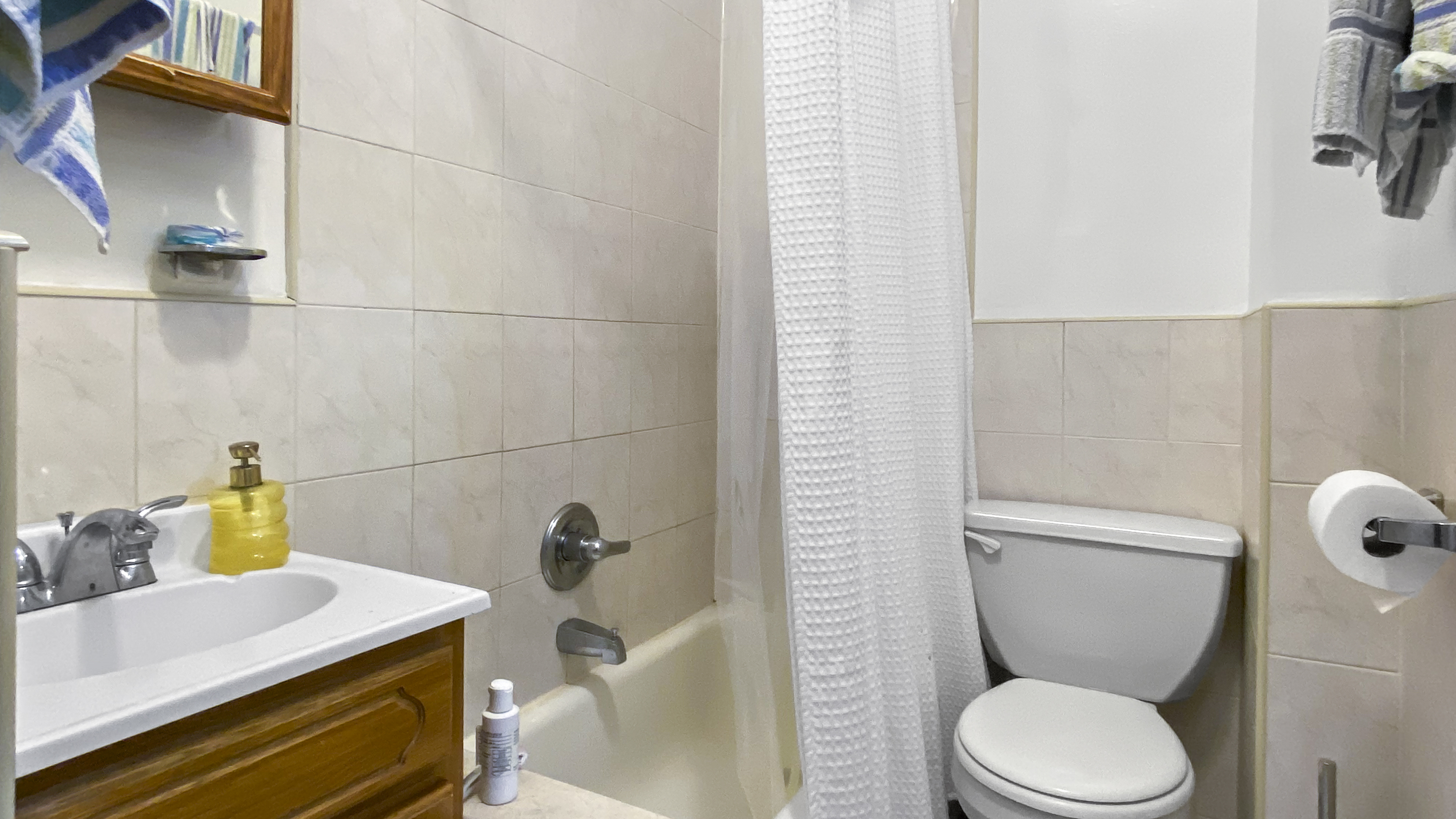 1059 2nd Avenue, Unit 3AB Manhattan, NY 10022 - Photo 6 of 8 a bathroom with a sink and toilet