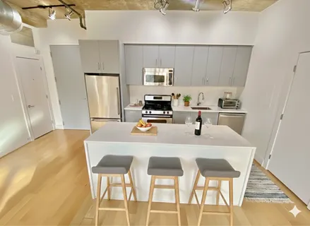 a kitchen with a dining table chairs and refrigerator