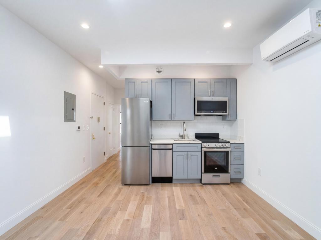 a view of a kitchen with microwave and cabinets