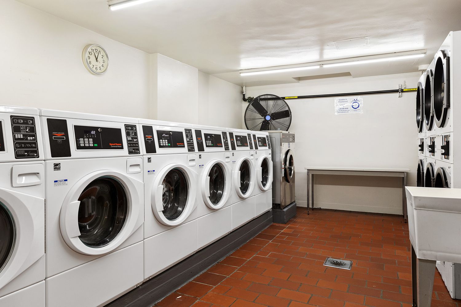 330 East 49th Street, Unit 9C Manhattan, NY 10017 - Photo 12 of 13 a utility room with dryer and washer