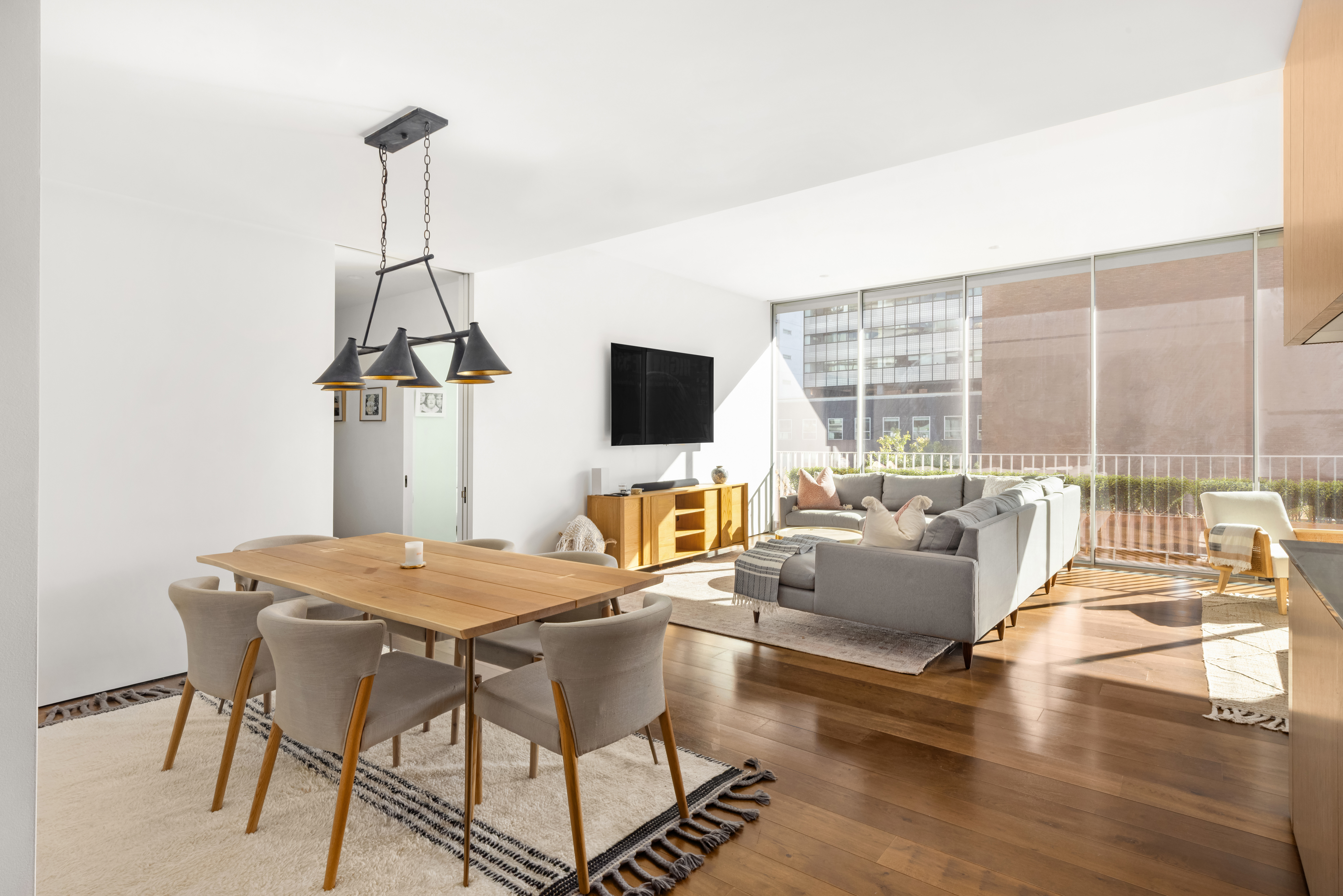 527 West 27th Street, Unit 4C Manhattan, NY 10001 - Photo 5 of 25 a view of a livingroom with furniture and flat screen tv