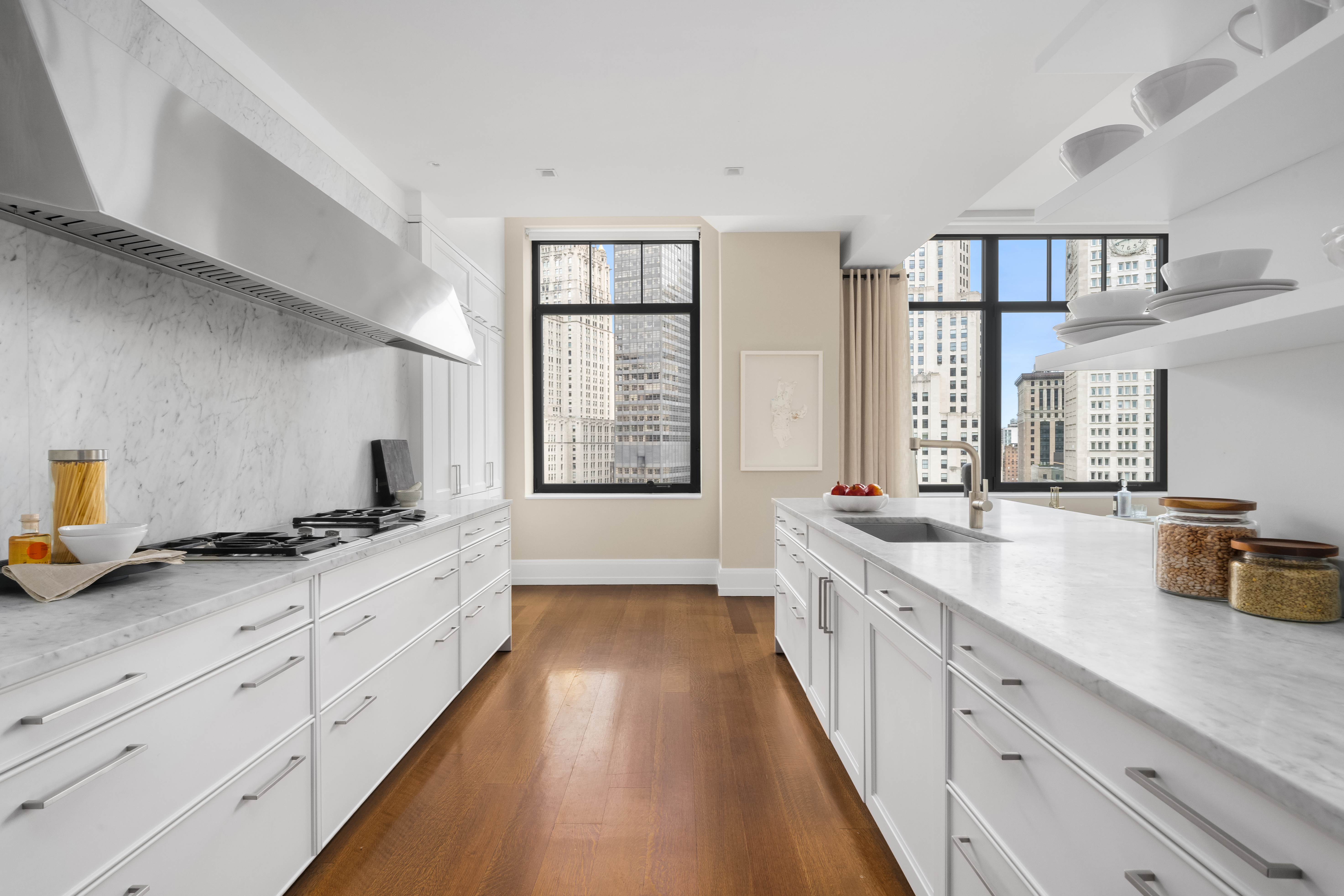 10 Madison Square West, Unit 12D Manhattan, NY 10010 - Photo 4 of 21 a large kitchen with a large window and stainless steel appliances