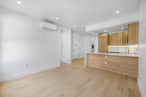 a view of large kitchen with granite countertop cabinets and wooden floor