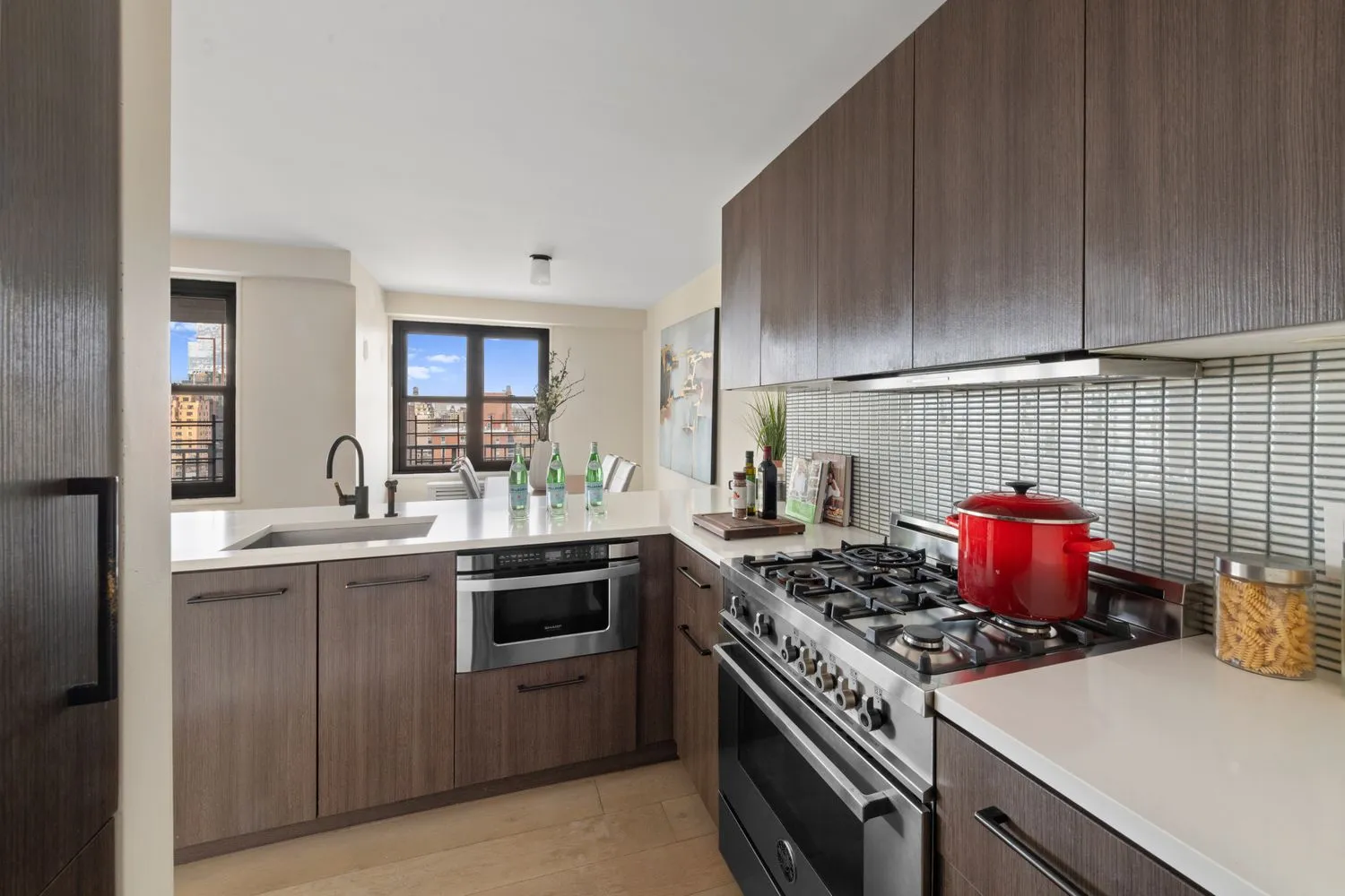 a kitchen with a stove and white cabinets