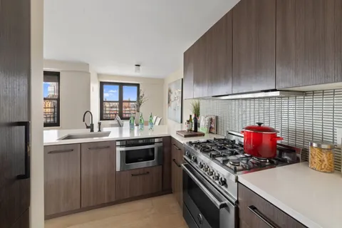 a kitchen with a stove and white cabinets