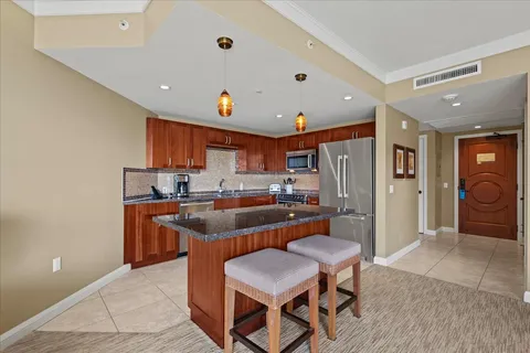 a kitchen with granite countertop a sink a counter top space appliances and cabinets