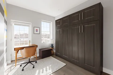 a view of a livingroom with furniture and a window