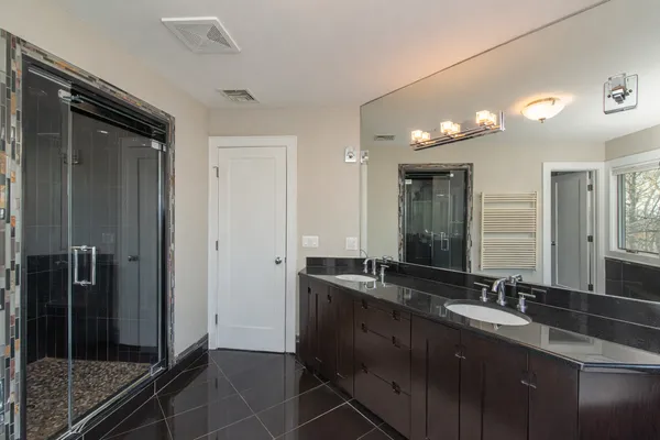 a bathroom with double sink and mirror