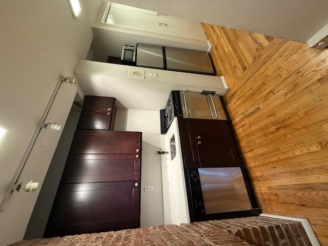 223 West 14th Street, Unit 1B Manhattan, NY 10011 - Photo 5 of 10 a kitchen with stainless steel appliances granite countertop a refrigerator a sink and a stove