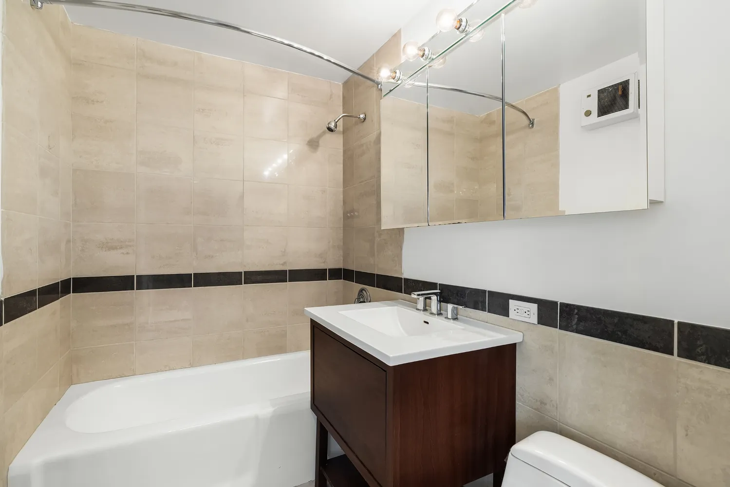 a bathroom with a sink mirror vanity and toilet