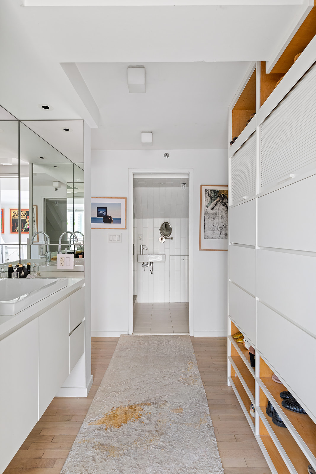 357 West 12th Street, Unit 5E Manhattan, NY 10014 - Photo 10 of 13 a large white kitchen with granite countertop a sink and dishwasher with a dining table