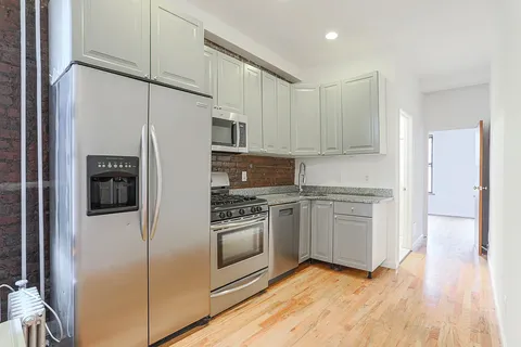 a kitchen with stainless steel appliances a refrigerator sink and microwave