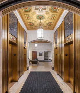 a lobby with furniture and chandelier