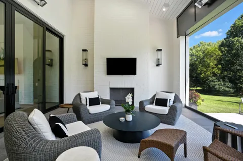 a kitchen with a stove a sink a refrigerator and chairs