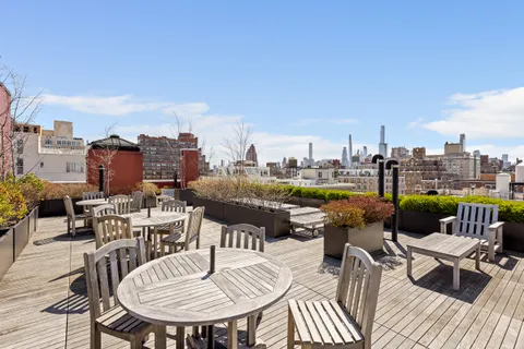 a terrace with outdoor seating city view and barbeque oven