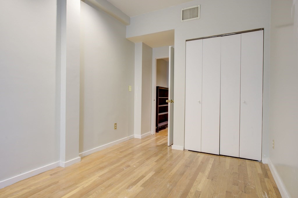 327 Commonwealth Avenue Boston, MA 02115 - Photo 24 of 26 a view of an empty room with wooden floor