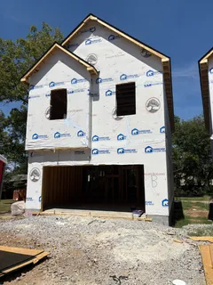 a front view of a house with large windows