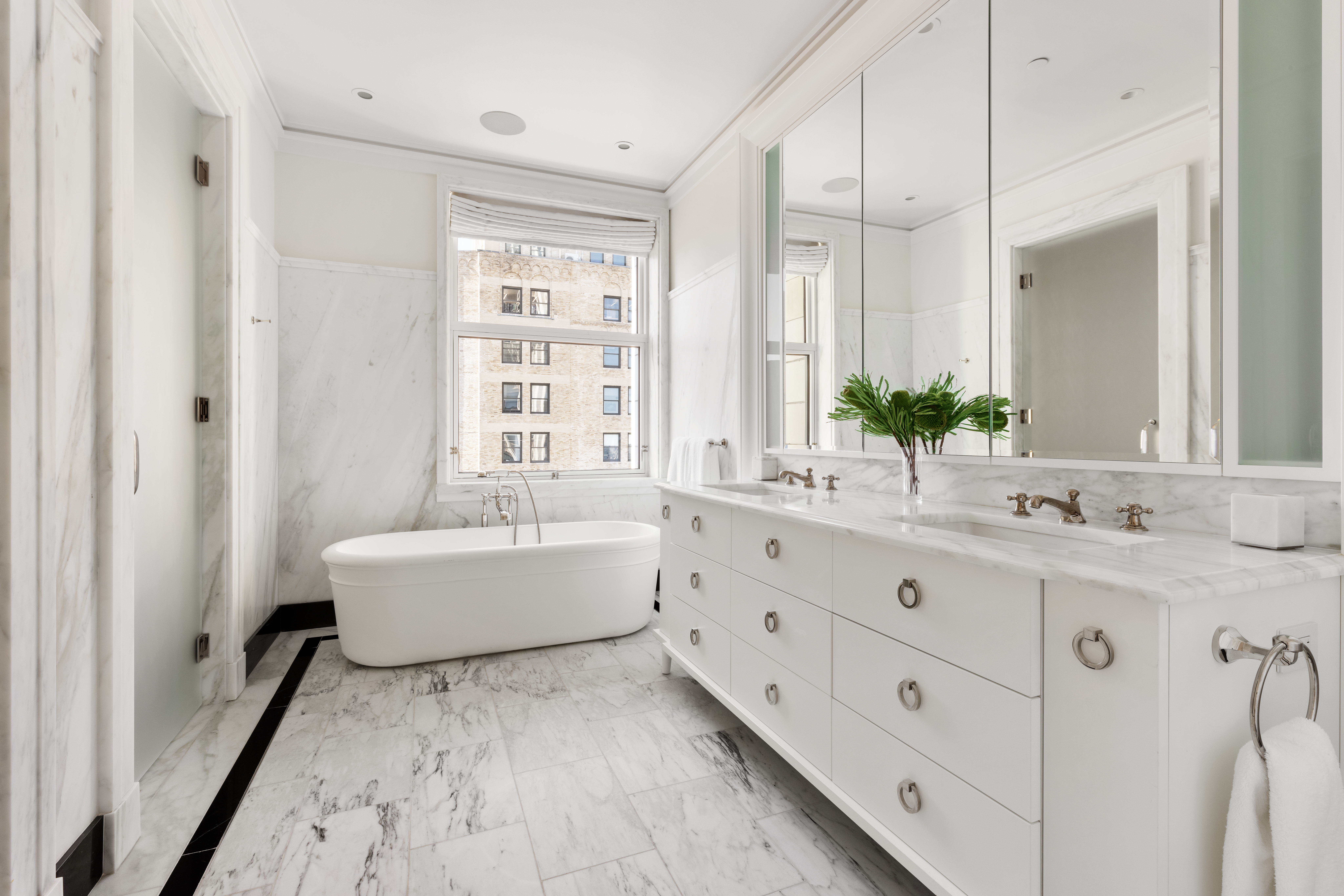 2 Park Place, Unit 35A Manhattan, NY 10007 - Photo 10 of 21 a bathroom with a granite countertop sink double vanity mirror bathtub and next to a window
