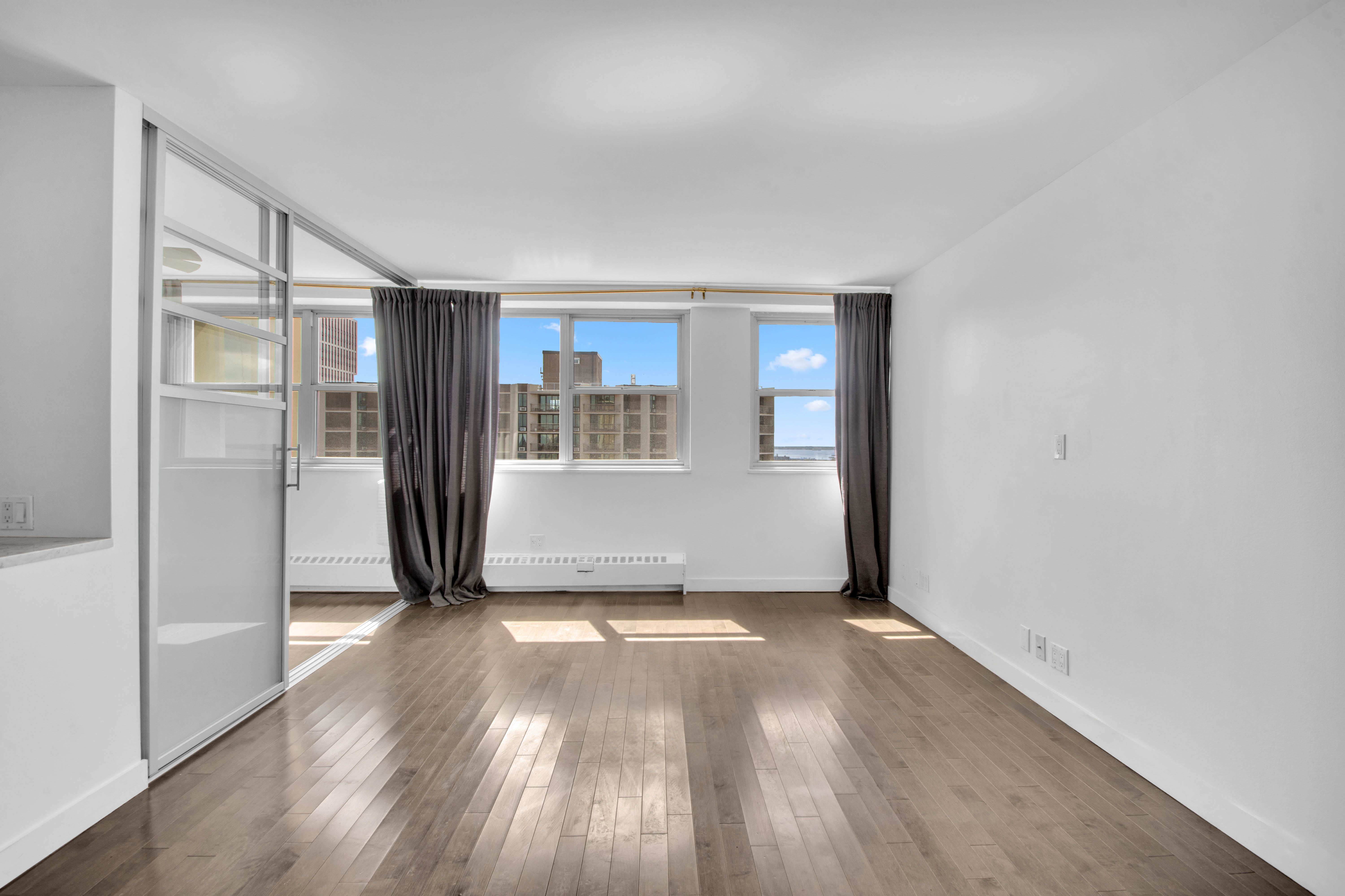 75 Henry Street, Unit 29J Brooklyn, NY 11201 - Photo 10 of 16 an empty room with wooden floor and entrance