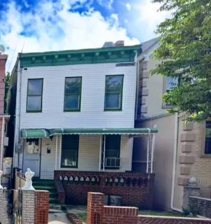 a front view of a house with plants