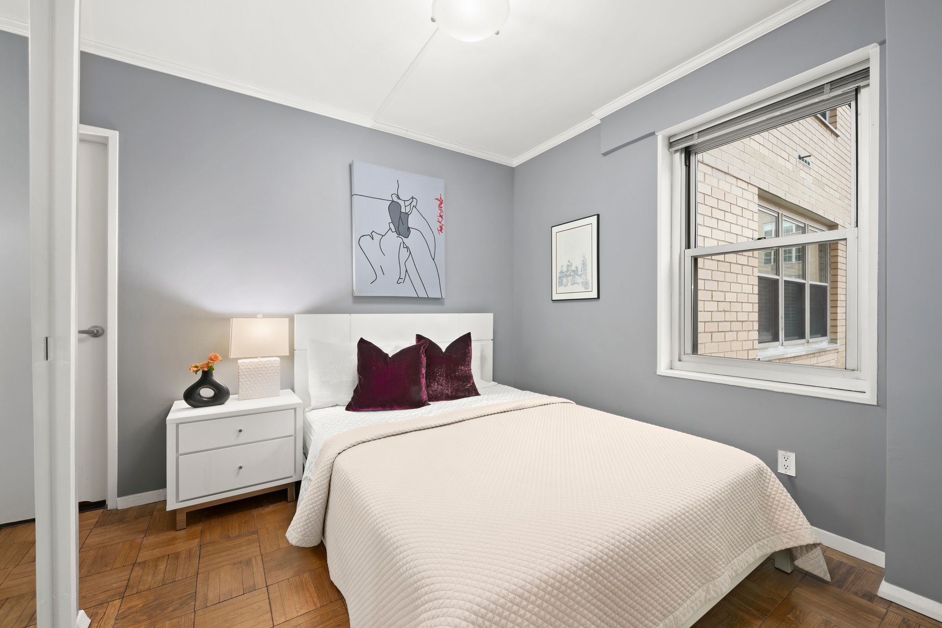 20 East 9th Street, Unit 9R Manhattan, NY 10003 - Photo 6 of 22 a bedroom with a white bed and a window