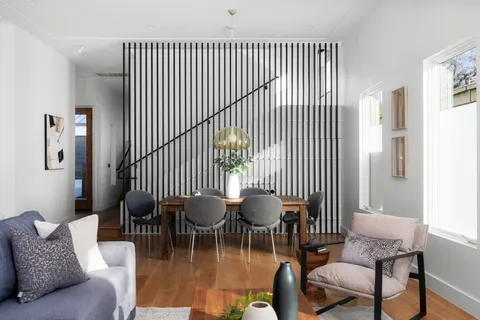 a dining room with furniture and wooden floor
