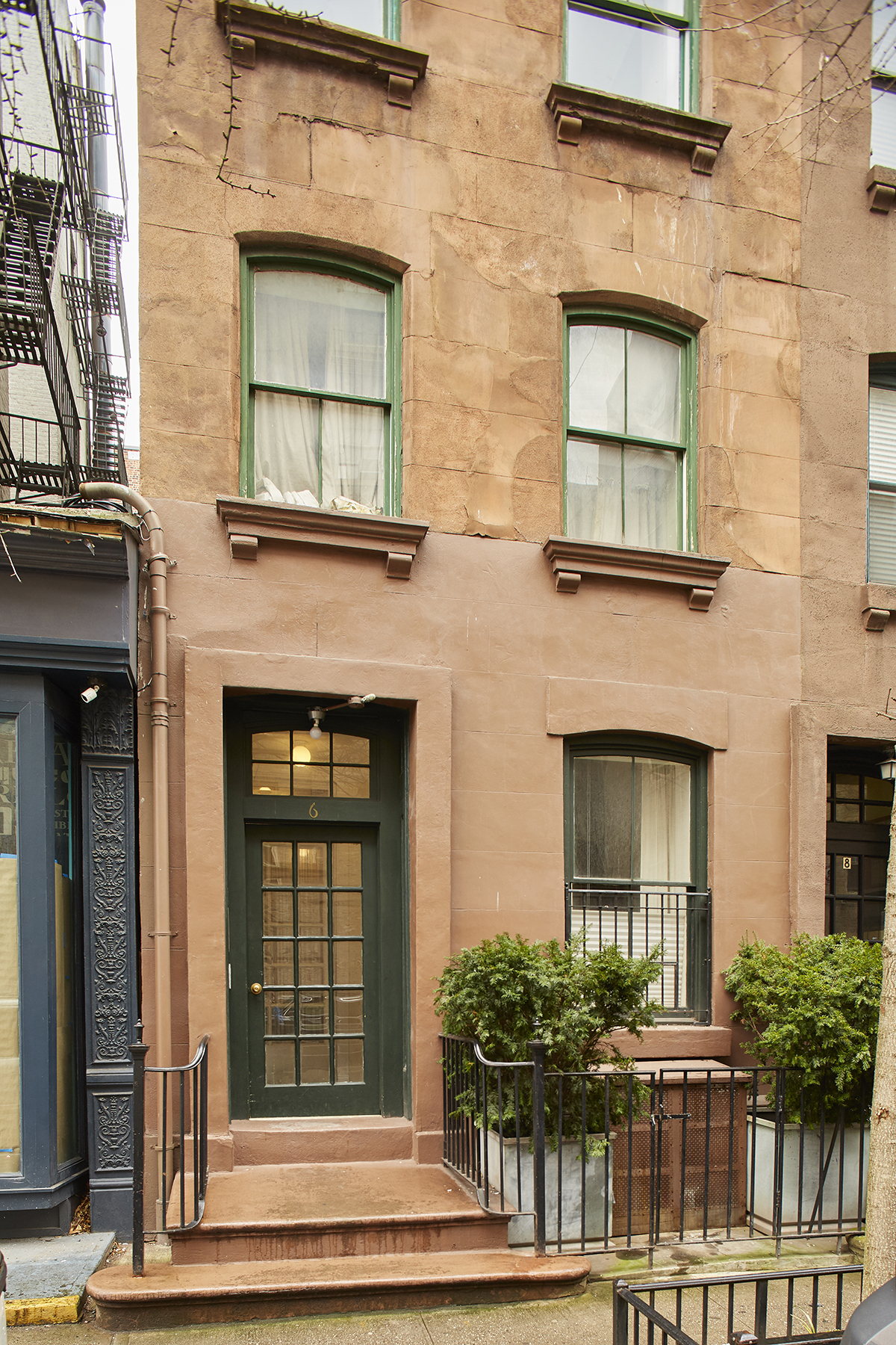 6 Bank Street, Unit 3 Manhattan, NY 10014 - Photo 5 of 6 front view of a brick house with a window and a potted plant