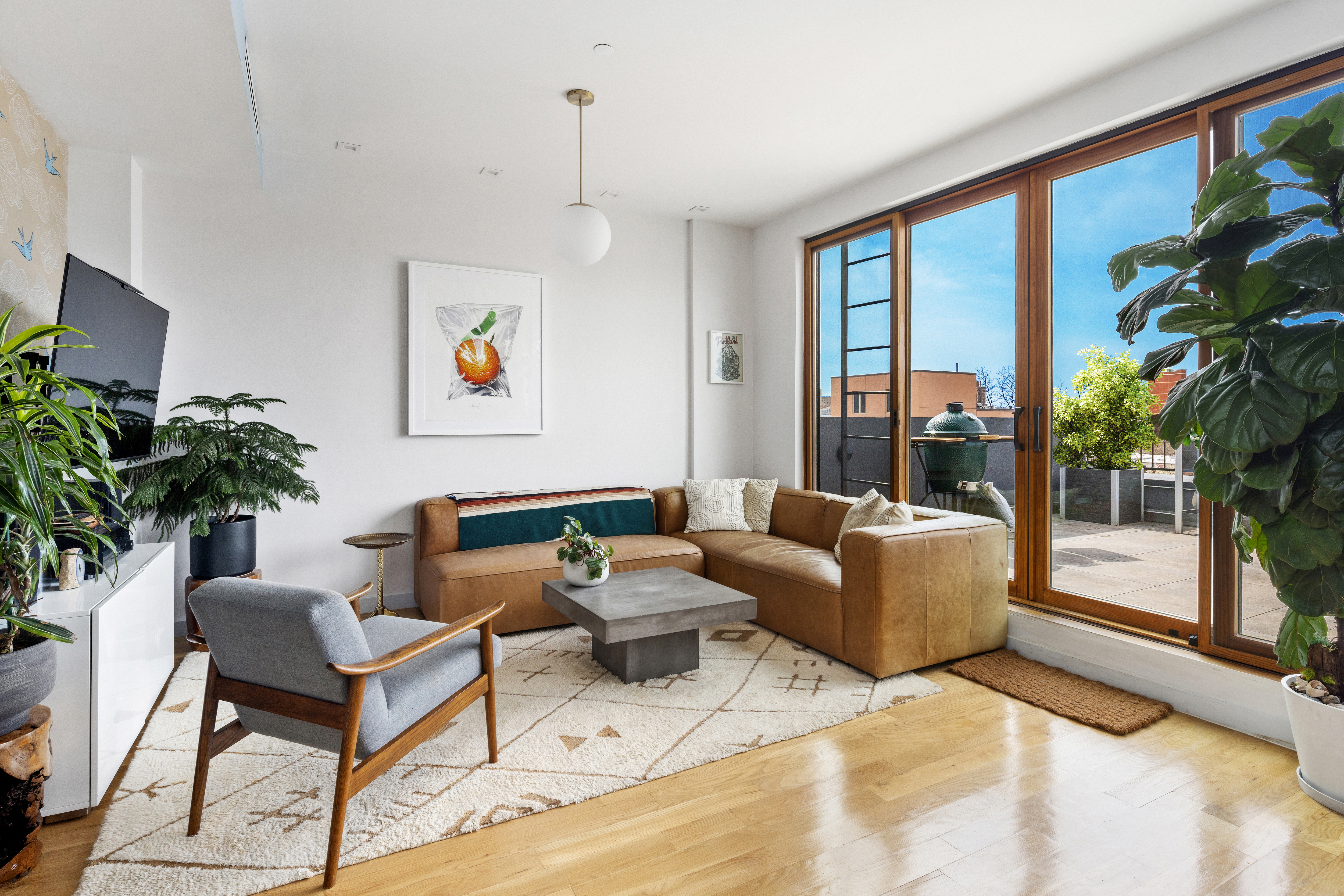 64 Stanhope Street, Unit PH Brooklyn, NY 11221 - Photo 2 of 13 a living room with furniture and a potted plant
