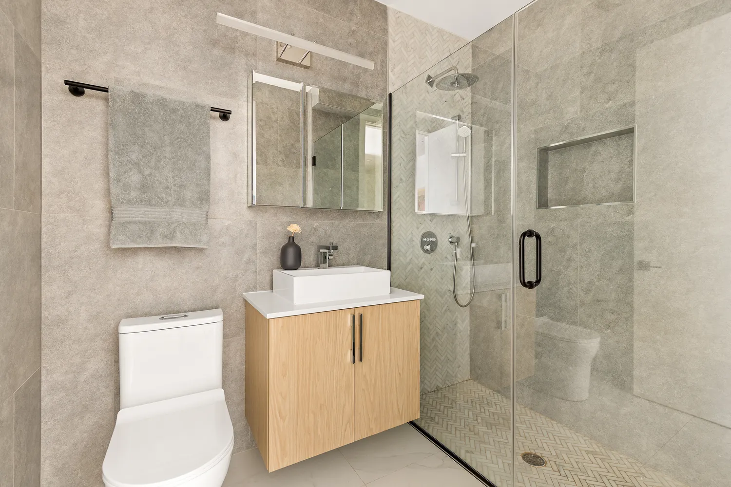 a bathroom with a sink a toilet and shower