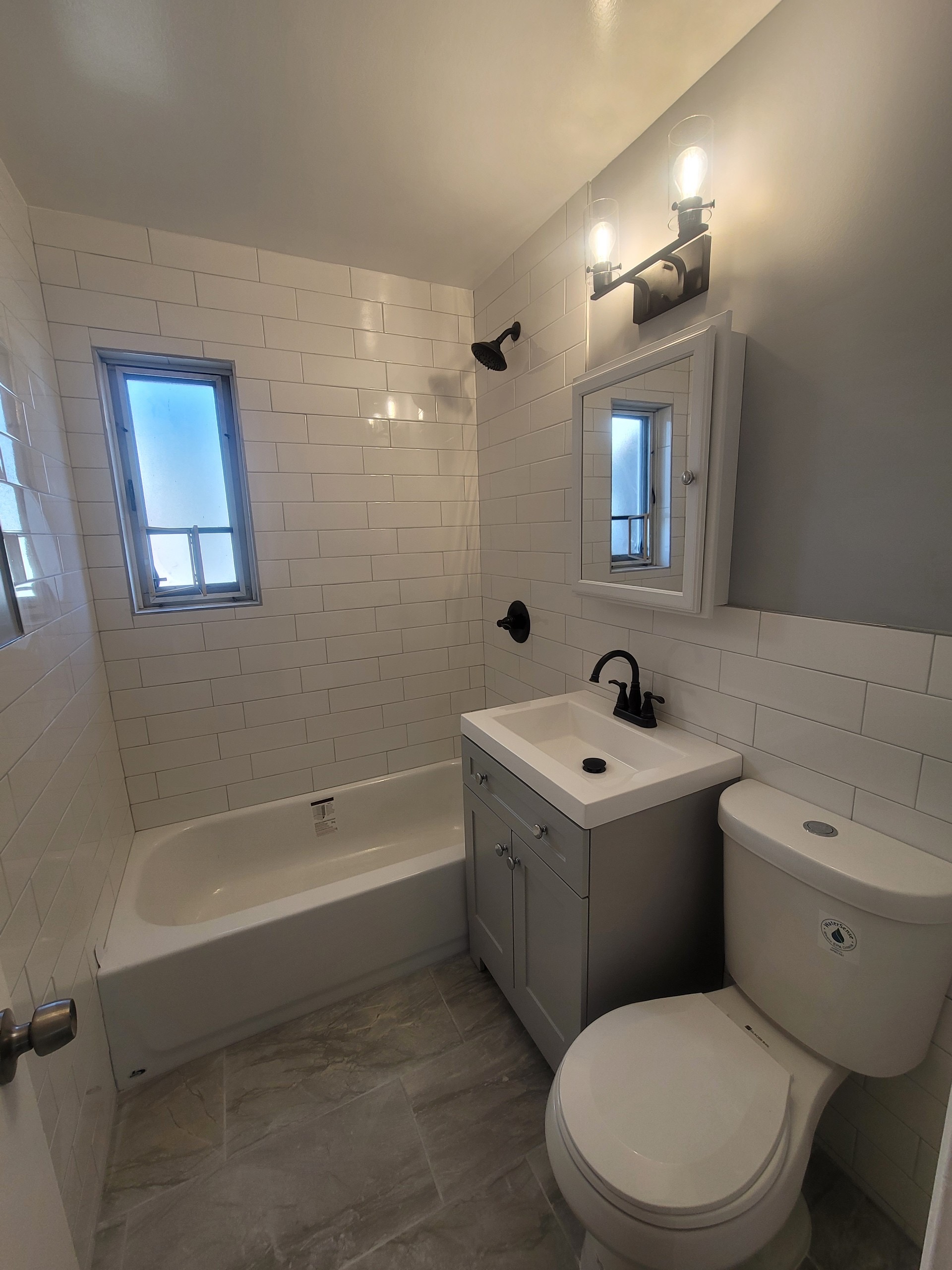 224-24 Manor Road, Unit U Queens, NY 11427 - Photo 9 of 10 a bathroom with a sink a toilet and bathtub