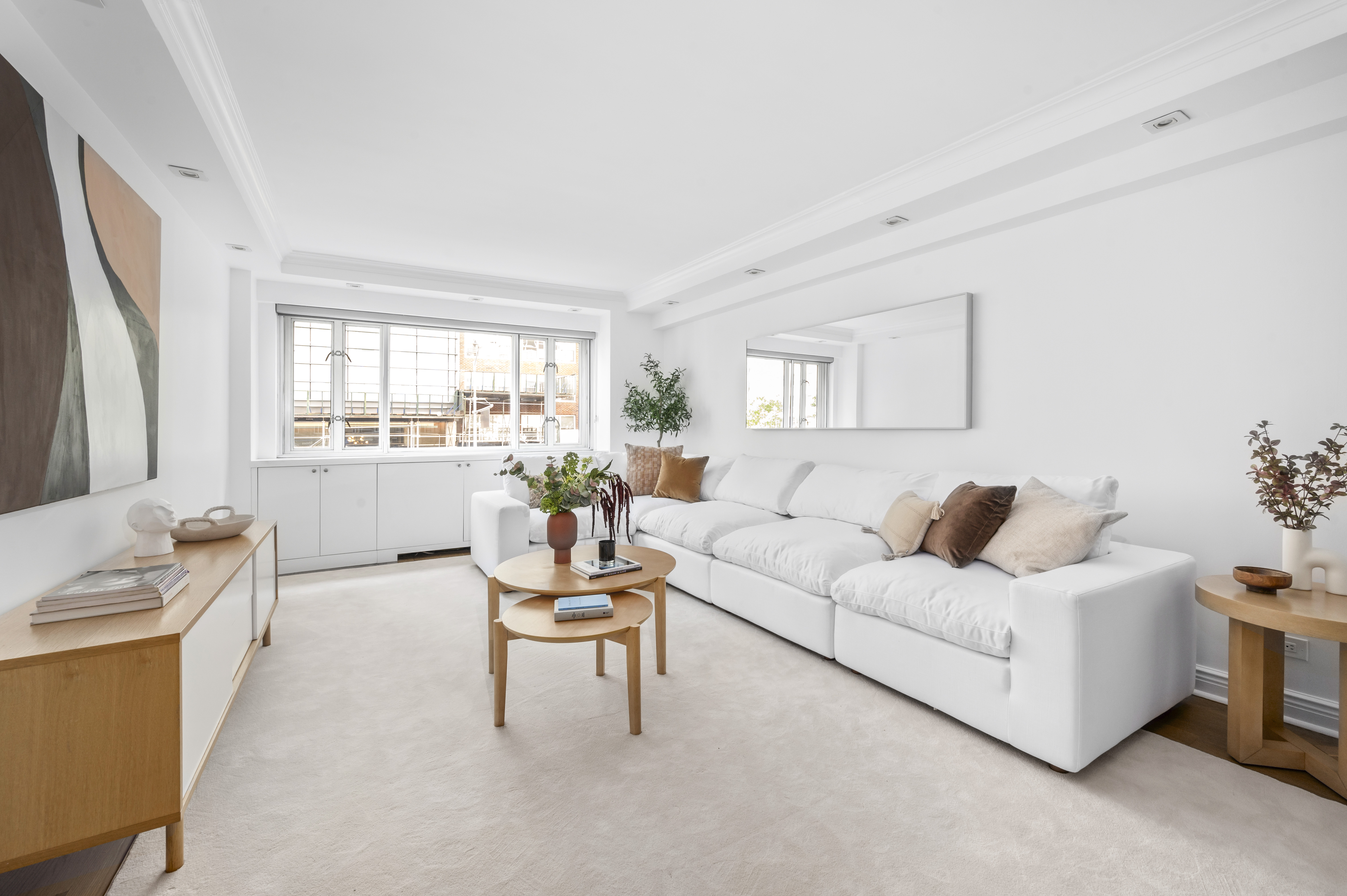 166 East 63rd Street, Unit 2J Manhattan, NY 10065 - Photo 3 of 14 a living room with furniture and a large window
