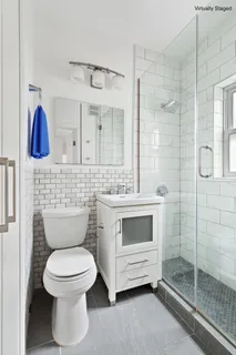 a bathroom with a toilet sink and shower