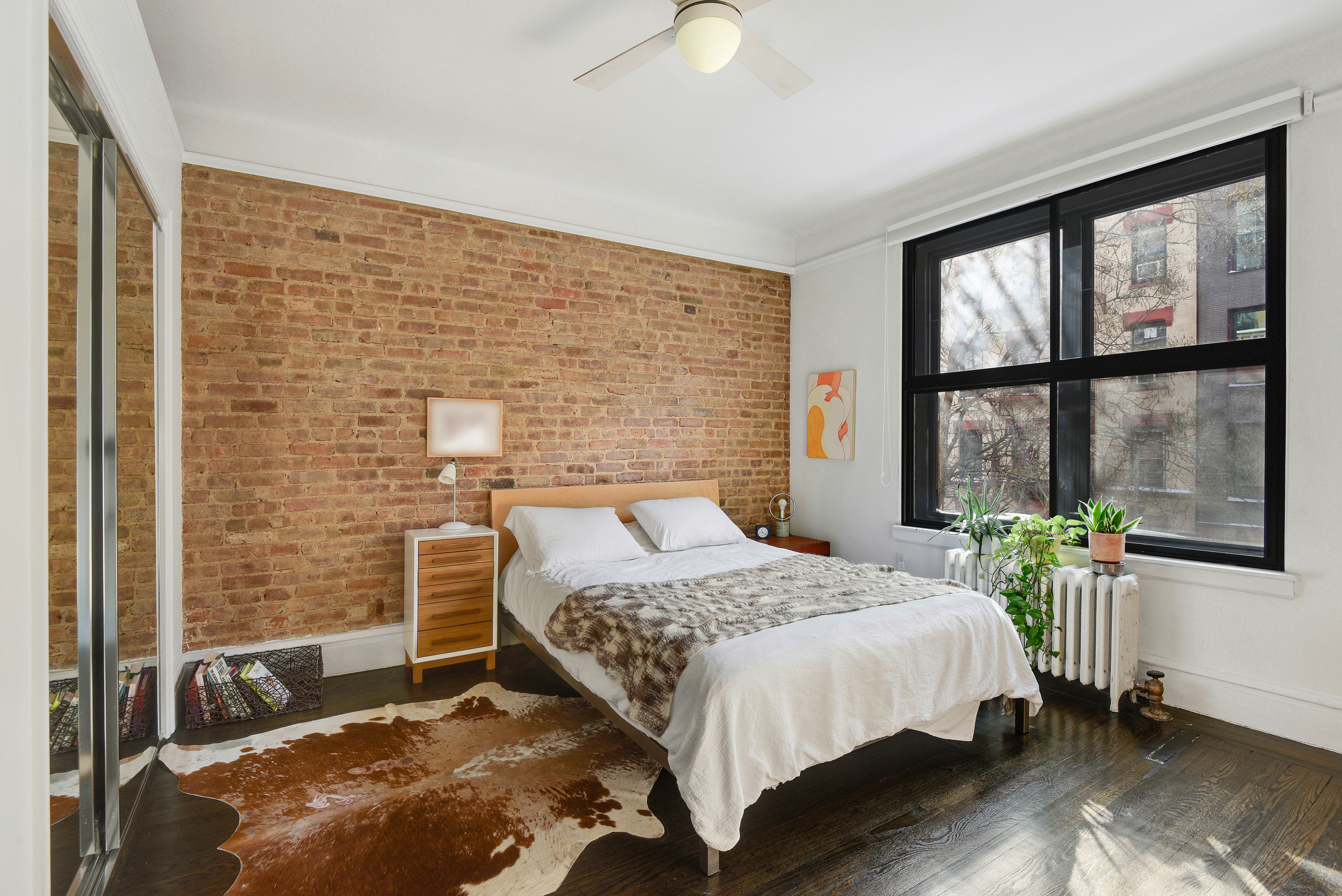 253 West 16th Street, Unit 3A Manhattan, NY 10011 - Photo 7 of 13 a bedroom with a bed and a window