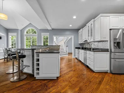 a kitchen with stainless steel appliances granite countertop a stove a sink and a refrigerator