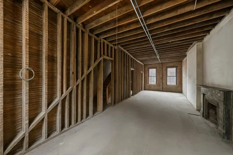 a view of an empty room with a fireplace