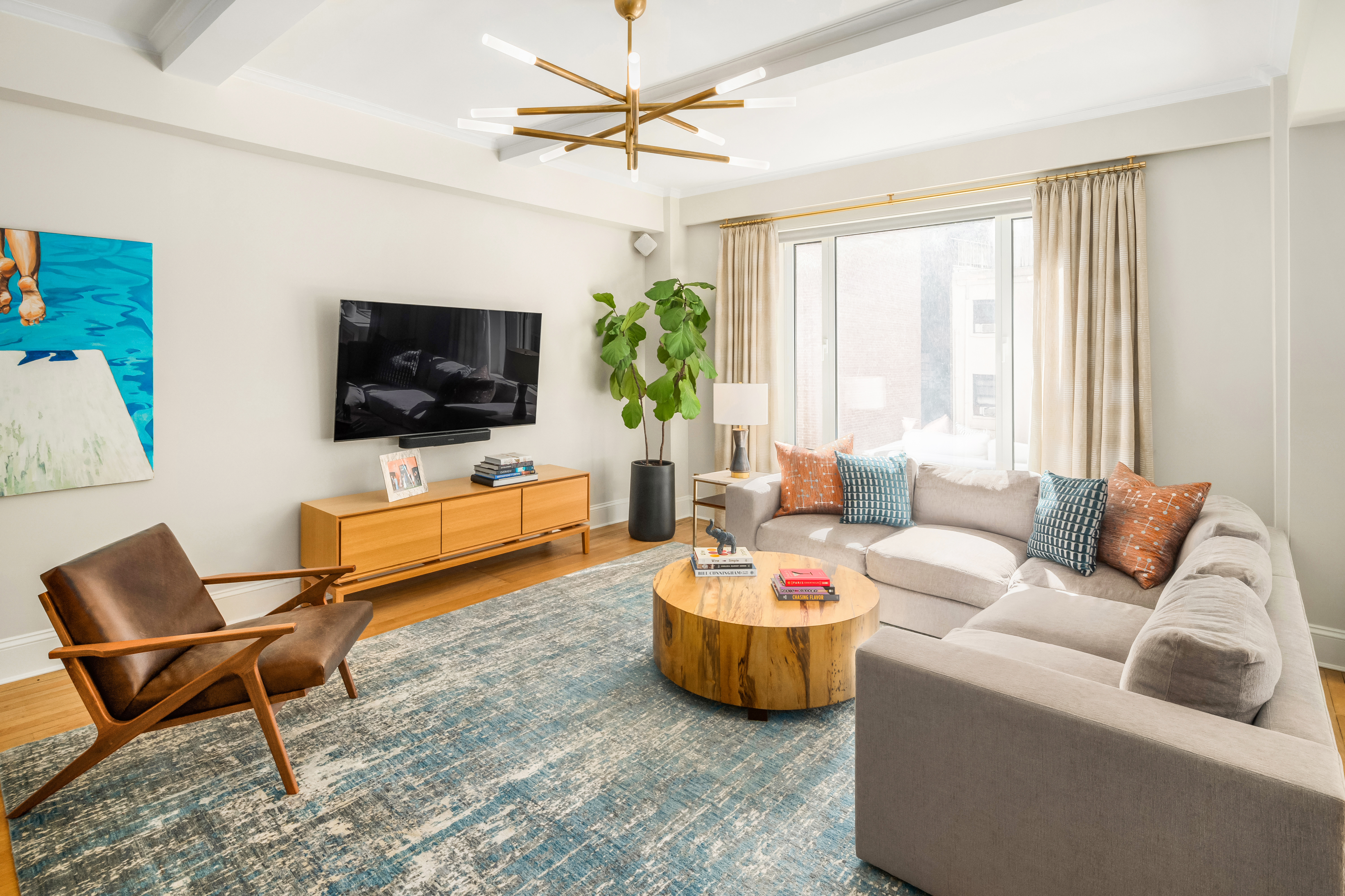 138 East 36th Street, Unit 4C Manhattan, NY 10016 - Photo 2 of 17 a living room with furniture and a flat screen tv