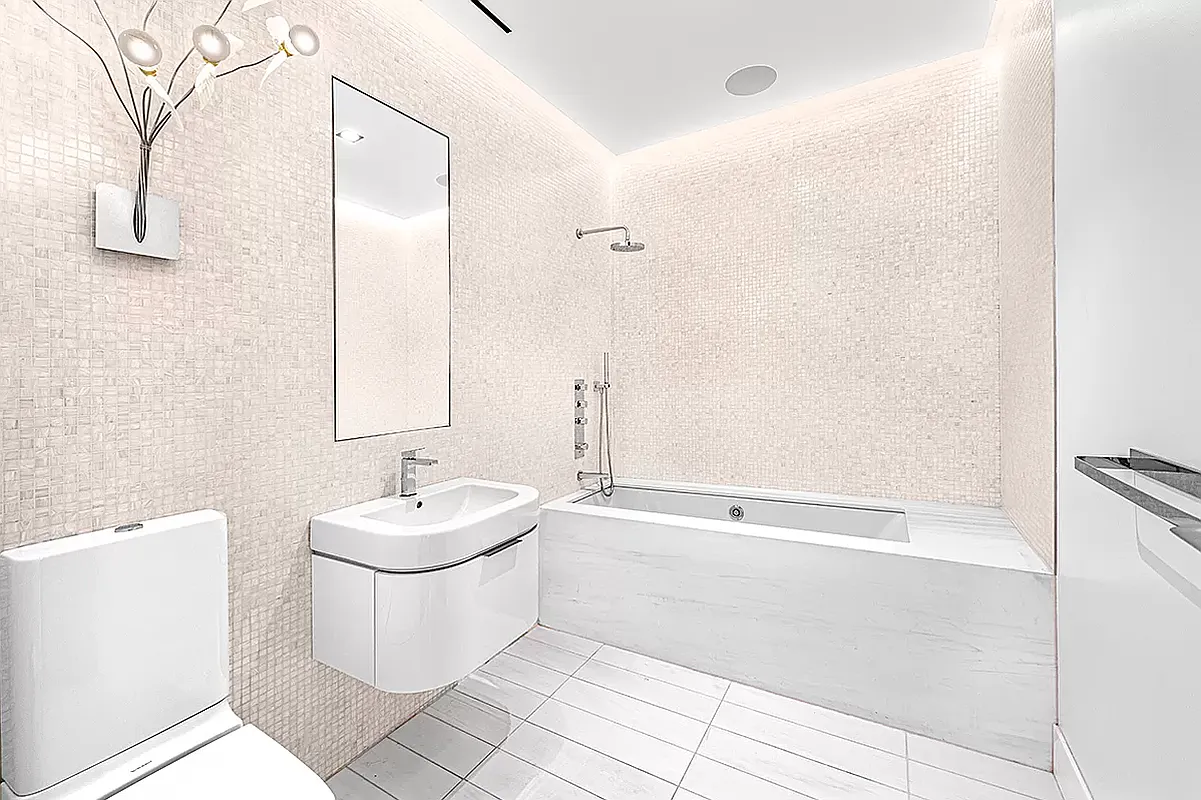 186 5th Avenue, Unit 4A Manhattan, NY 10010 - Photo 9 of 12 a bathroom with a sink a toilet and shower