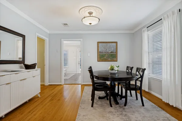 a view of a dining room with furniture and wooden floor
