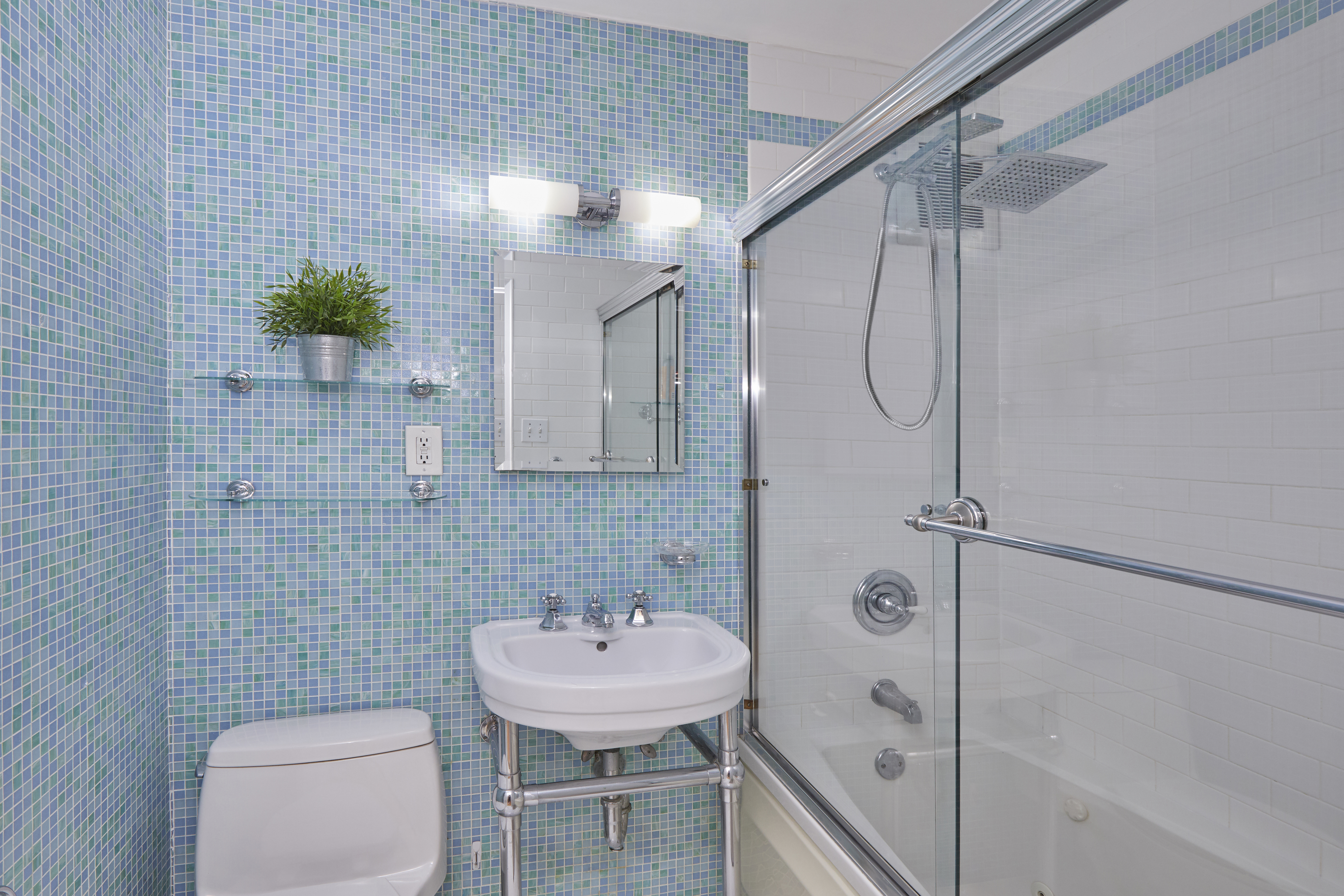 3135 Johnson Avenue, Unit 5D Bronx, NY 10463 - Photo 5 of 7 a bathroom with a sink a toilet and shower