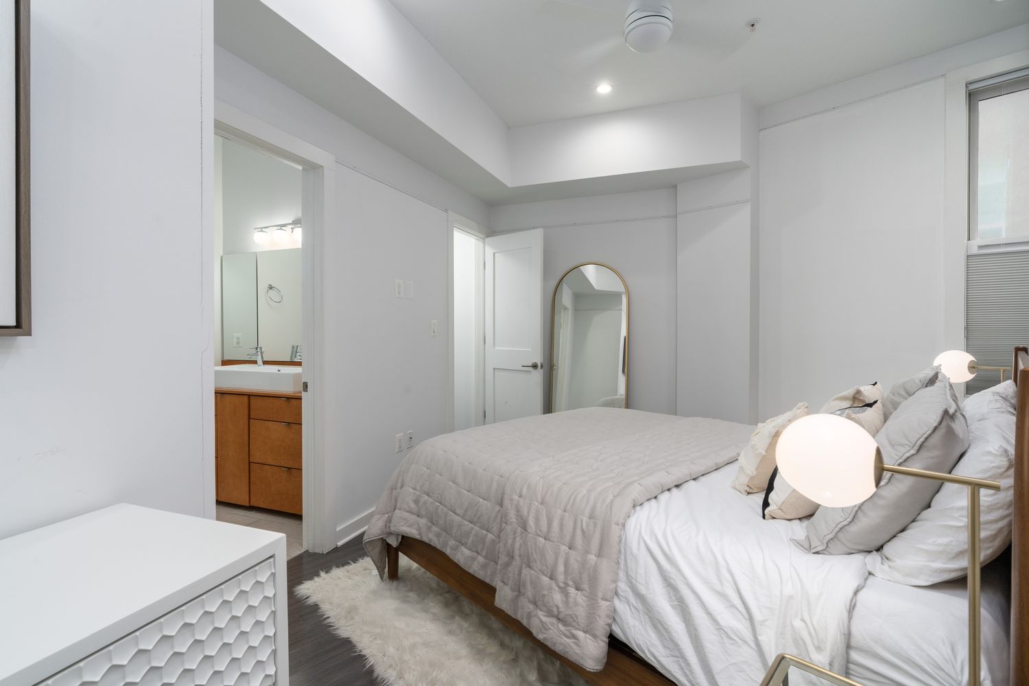 a bedroom with a bed and a dresser