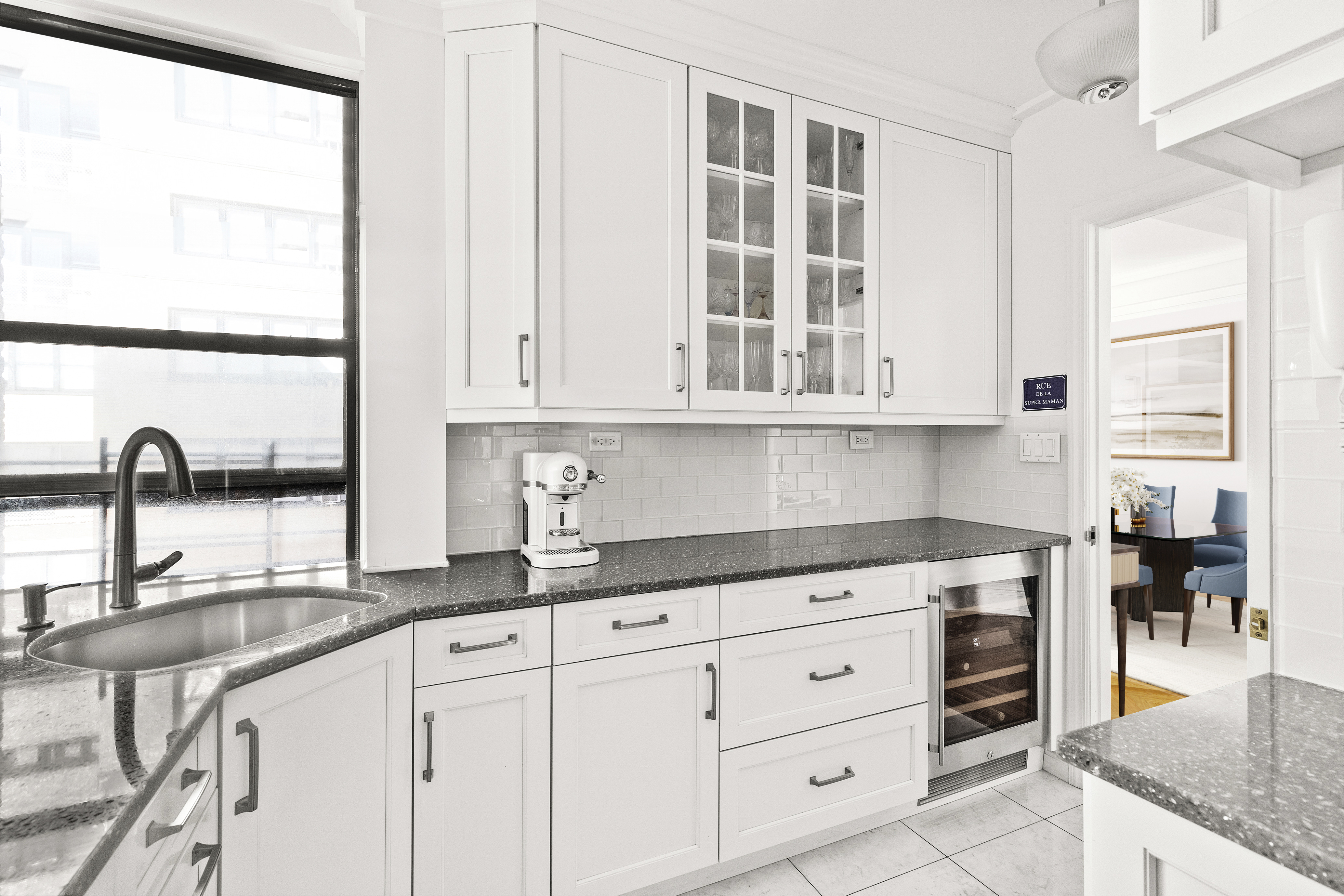 410 East 57th Street, Unit 15BE Manhattan, NY 10022 - Photo 6 of 18 a kitchen with stainless steel appliances granite countertop a sink and cabinets with wooden floor